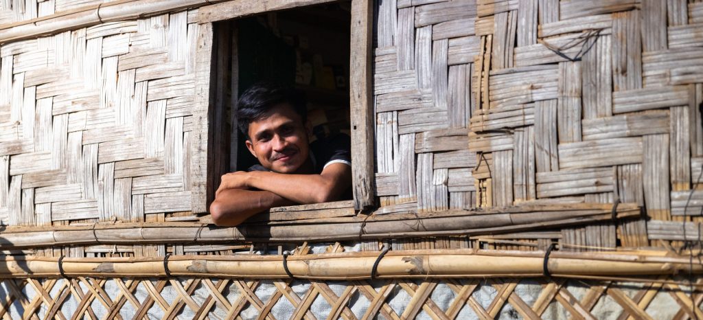 A young man looks out of his shelter in the Rohingya refugee camps in Bangladesh.