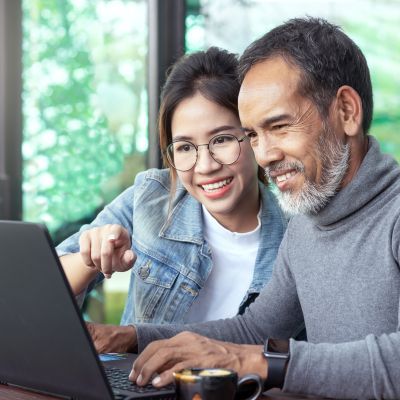 two people donating on a laptop